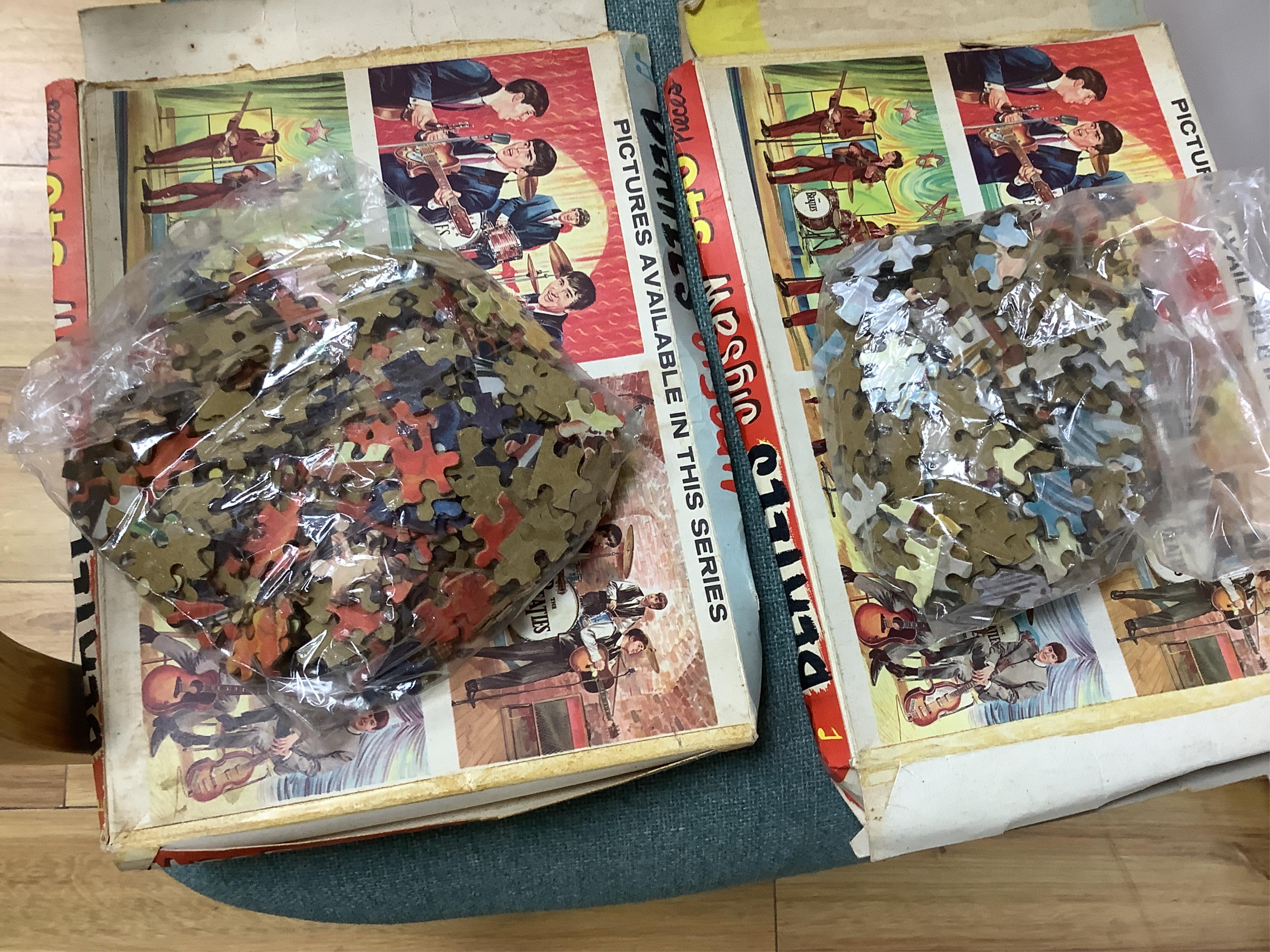 A 1960's Beatles child's plastic drum set in the original card box comprising of a snare drum on a stand, a card cut out bust of Ringo Starr, two 1960s Beatles jigsaws (unchecked) and a Beatles inflatable ball